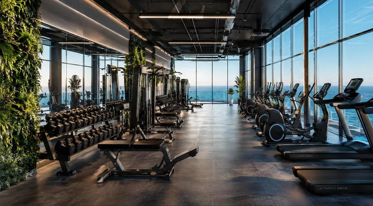 Fitness area with a green wall and windows facing the sea, in a Z VIEW concept image